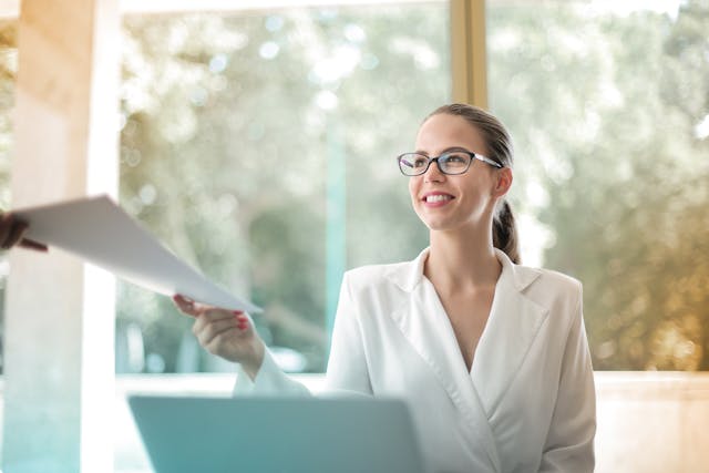 person%20smiling%20while%20being%20handed%20documents person%20smiling%20while%20being%20handed%20documents